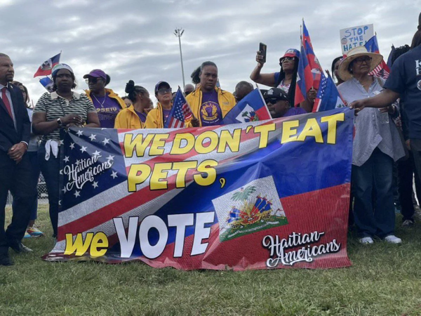 Haitians outside trumps rally in uniondale v0 po2bix08aopd1.jpeg.